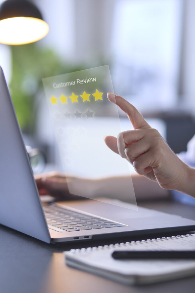Woman Using Laptop With Graphic Overlay To Leave Positive 5 Star Online Review